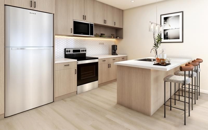 a kitchen with an island and chairs