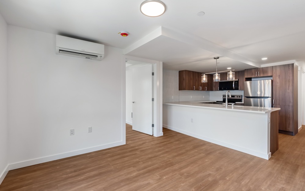 a living room and kitchen with wood floors