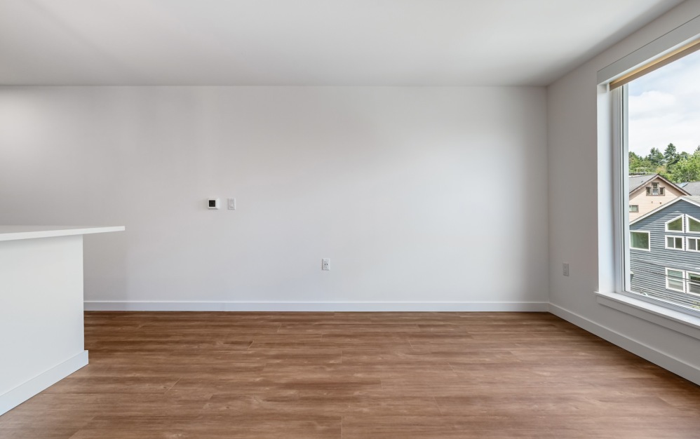 a living room with wood floors and a window