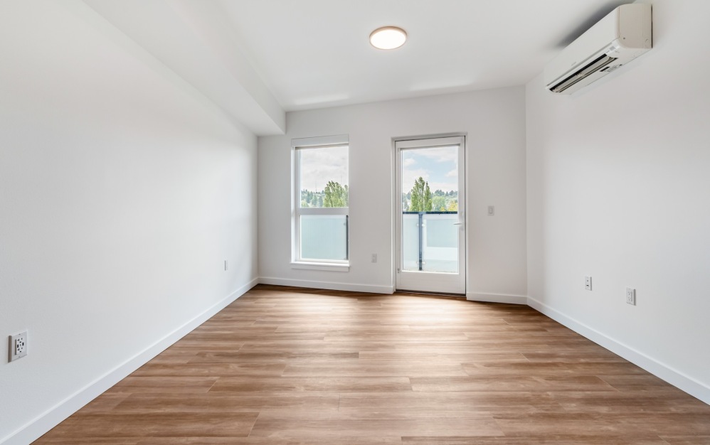 a living room with wood floors and windows