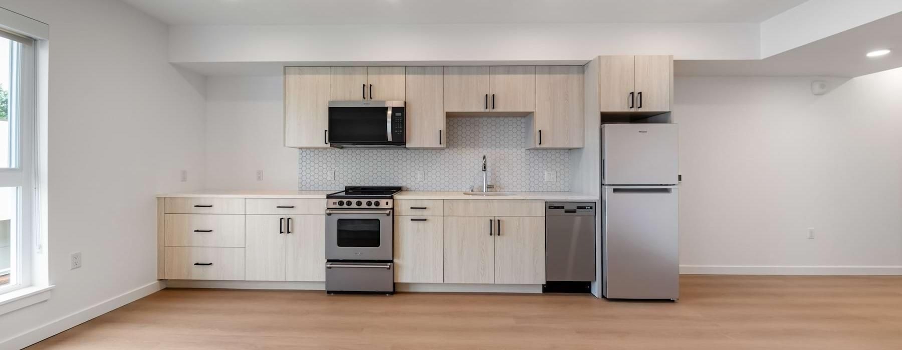 a kitchen with wood cabinets and stainless steel appliances