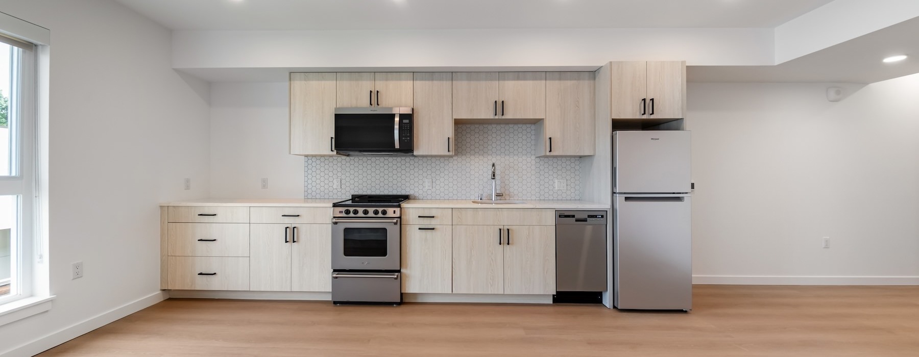 a kitchen with wood cabinets