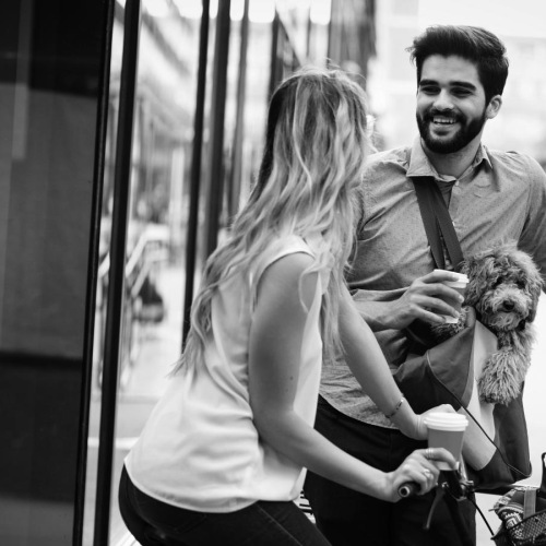a man and woman riding a bicycle